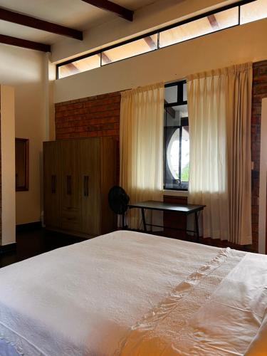 a bedroom with a large bed and a window at DELUX in Tarapoto