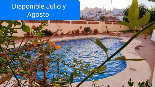 a swimming pool in the middle of a building at Vivienda Turística Playa El Portil in El Portil