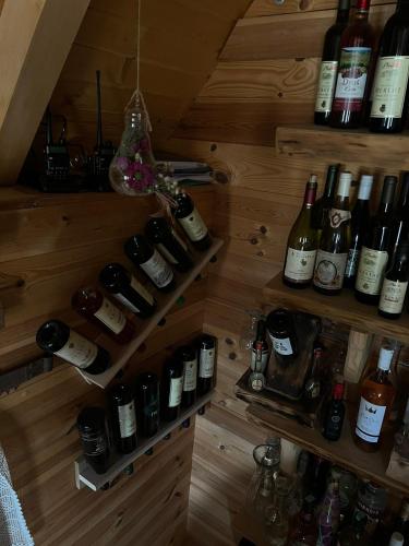 a room filled with lots of bottles of wine at Black Wood in Žabljak