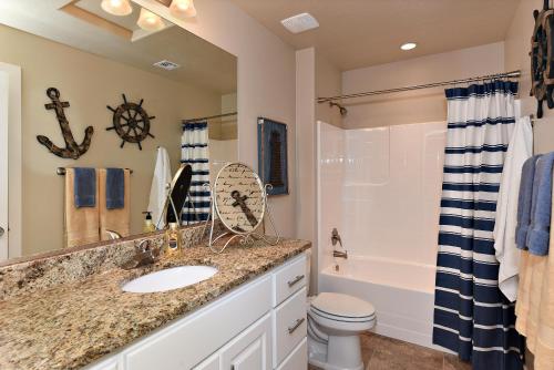 a bathroom with a sink and a toilet and a shower at Desert Dream in St. George