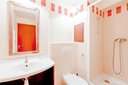 La salle de bains est pourvue d'un lavabo, de toilettes et d'un miroir. dans l'établissement Résidence Le Tikal - maeva Home - 3 Pièces 6 Personnes Budget 54, à Val Thorens
