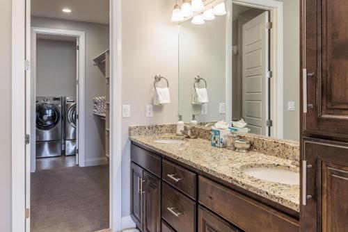 a bathroom with two sinks and a large mirror at 18th Fairway to Heaven in St. George