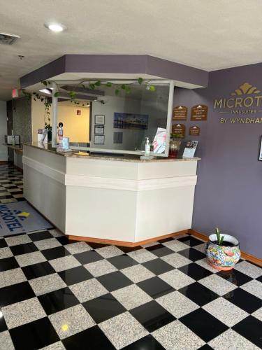 a fast food restaurant with a counter and checkered floor at Microtel Inn & Suites by Wyndham Amarillo in Amarillo