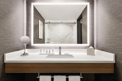 a bathroom with a sink and a mirror at Radisson Blu Vancouver Airport Hotel & Marina in Richmond