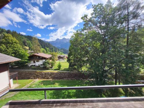 a view from the balcony of a house with a tree at Apartment Wildbach in Lenk