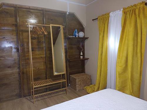 a bedroom with a shower and a mirror and a bed at Cottage Haven Escape in Portsmouth