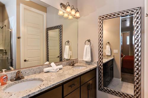 a bathroom with two sinks and a large mirror at Eagle's Ledge in St. George