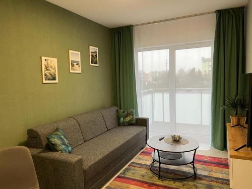 a living room with a couch and a table at Apartament Zacisze 14 in Piaseczno