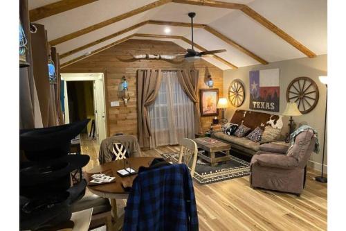 a living room with a couch and a table at Stockyards-Walk 1 Block to StockYards-Cowboy Cabin in Fort Worth
