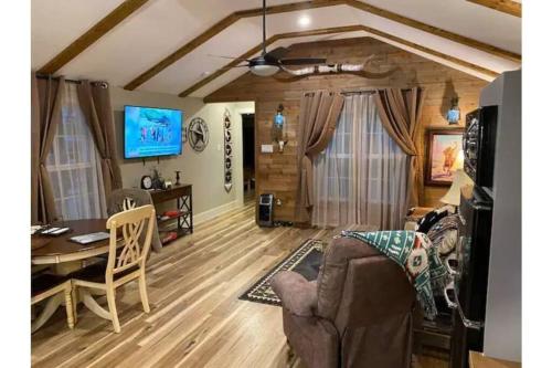 a living room with a couch and a table at Stockyards-Walk 1 Block to StockYards-Cowboy Cabin in Fort Worth