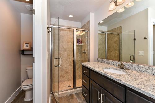 a bathroom with a shower and a sink and a toilet at The View At The Escapes in St. George
