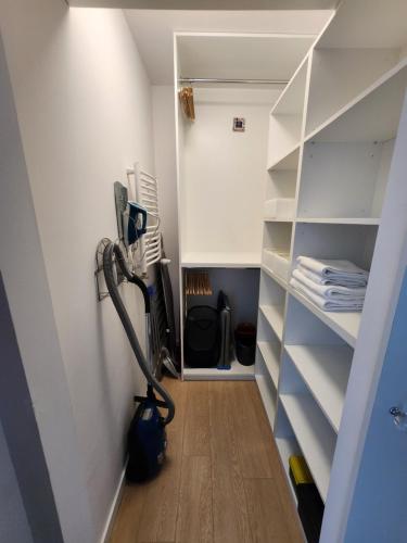 a room with a vacuum cleaner in a closet at Premium Spire Apartment +parking in Warsaw