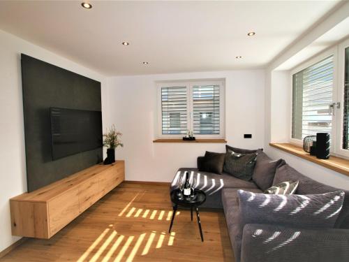 a living room with a couch and a flat screen tv at Apartment Christine by Interhome in Brixlegg