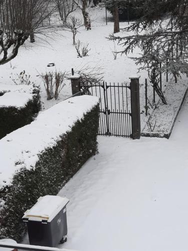 a trash can in the snow next to a fence at Goutanou 01200 in Châtillon-en-Michaille