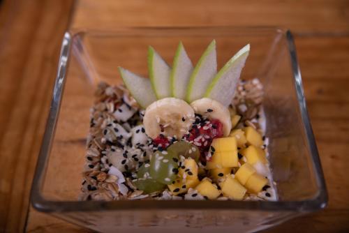 a glass container filled with fruit and vegetables at Hostal Copart in San Pedro de Atacama