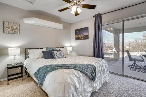 a bedroom with a bed and a ceiling fan at Inviting Home with Lake View 2 Mi to Lake Havasu! in Lake Havasu City