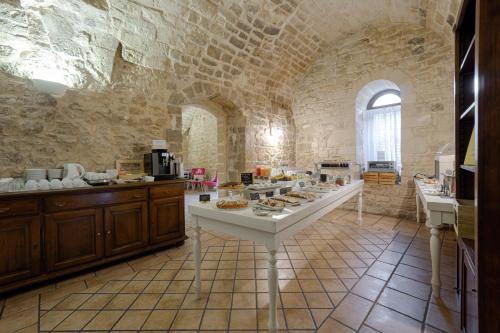 a large kitchen with a table with food on it at Itria Palace in Ragusa