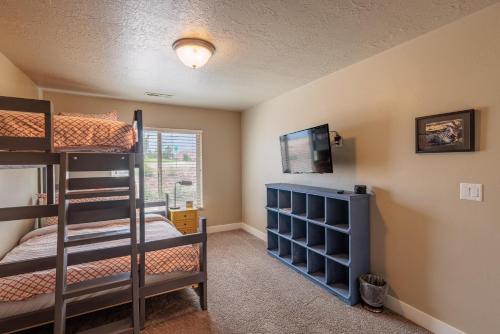 1 dormitorio con 2 literas y TV en Suite Escapes, en Ivins