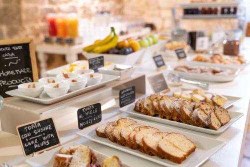 a buffet of different types of bread and pastries at Itria Palace in Ragusa