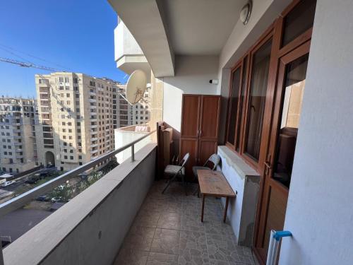 a balcony with a bench and a view of a city at Glendel hilz in Yerevan