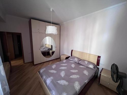 a bedroom with a bed and a mirror at Glendel hilz in Yerevan