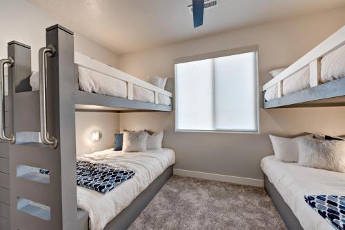 two bunk beds in a room with a window at Villa On The 18th in Ivins