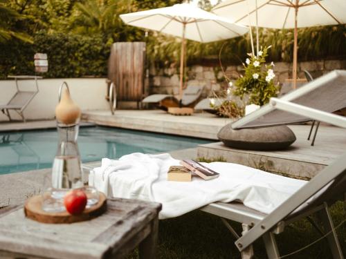 a table with an apple on it next to a pool at Hotel Villa Freiheim in Merano