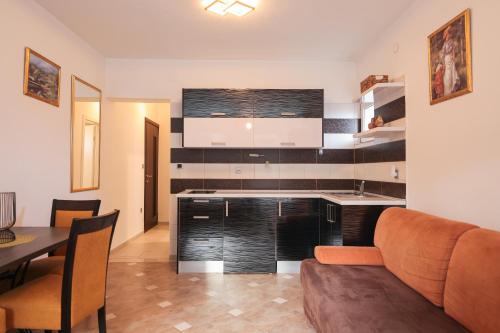 a kitchen and living room with a couch and a table at Villa Eni in Bibinje
