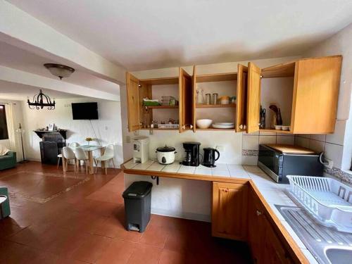 a kitchen with wooden cabinets and a counter top at Finca La Luna - Bed & Breakfast on an organic farm in Concepción