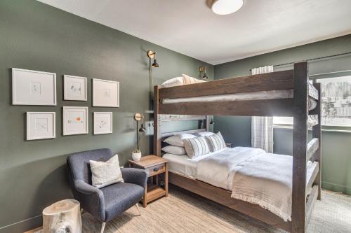 a bedroom with a bunk bed and a chair at Downtown Winter Park Condo with Free Bus to Ski Base in Winter Park