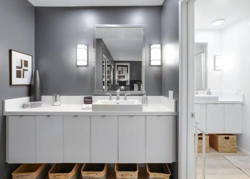 a bathroom with a sink and a mirror at Chic Downtown Bungalow - A Ryson Property in Palm Springs