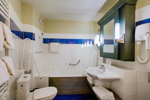 une salle de bain avec toilettes, lavabo et baignoire dans l'établissement Résidence Les Arcs 1950 Le Village - maeva Home - 2 pièces 4 personnes Sélection MAE-9500, à Bourg-Saint-Maurice