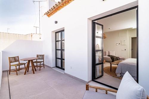 a room with a table and chairs and a bedroom at Seaclub Suites Estepona in Estepona