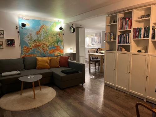 a living room with a couch and a map on the wall at Charming holiday home on the harbour (5 persons) in Rødvig