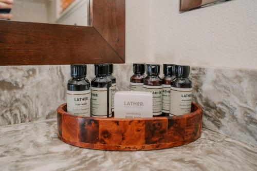 a group of five bottles of ink on a wooden tray at Pantai Inn in San Diego