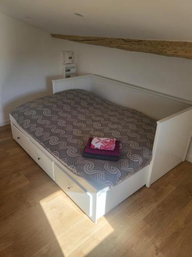 a bed with a suitcase sitting on top of it at Top studio + Parking + Wifi in Toulon