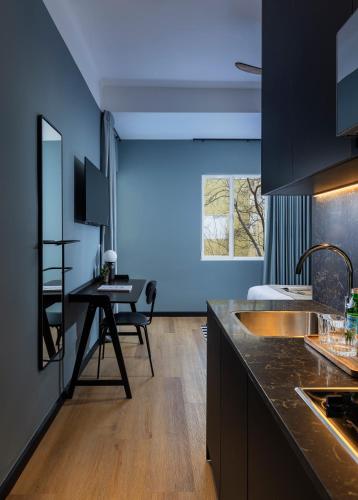 a kitchen with a sink and a desk in it at Albi Florentin - Traveler's Choice 2025 in Tel Aviv