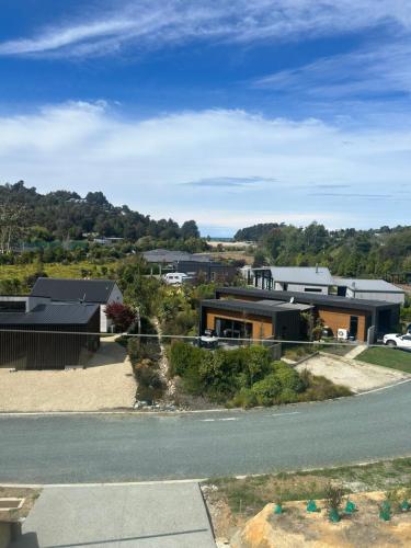 a house on the side of a road at KOTARE – Stunning Kaiteriteri Holiday Home in Kaiteriteri