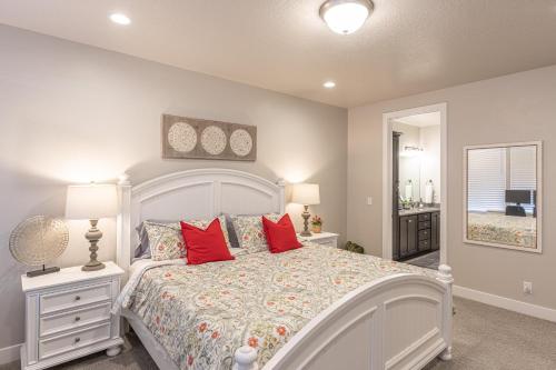 ein Schlafzimmer mit einem großen weißen Bett mit roten Kissen in der Unterkunft Launchpad in St. George