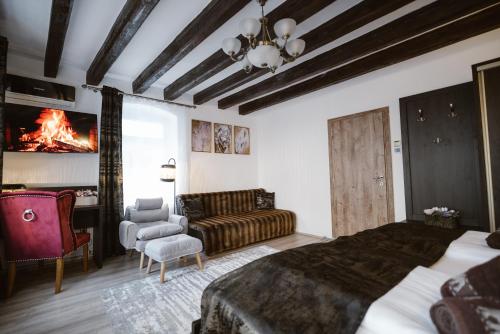 a bedroom with a bed and a couch and a fireplace at Hermannstadt House in Sibiu