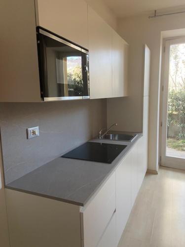 a kitchen with a sink and a counter top at Villa Gaia appartamenti con piscina Seeblick in Malcesine