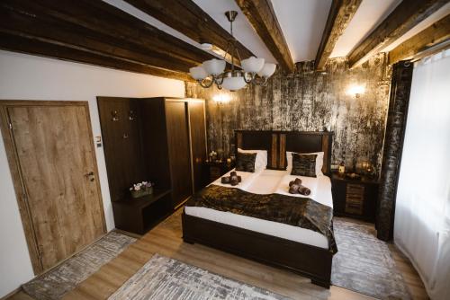 a bedroom with a large bed with two dogs on it at Hermannstadt House in Sibiu