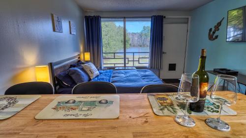 Cette chambre comprend une table avec des verres à vin et un lit. dans l'établissement Bells Marina & Fishing Resort - Santee Lake Marion by I95 - Family Adventure, Pets on Request!, à Eutawville