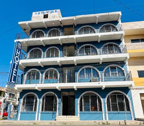 a blue building with barred windows on a street at Hotel Santa Barbara in Mazatlán