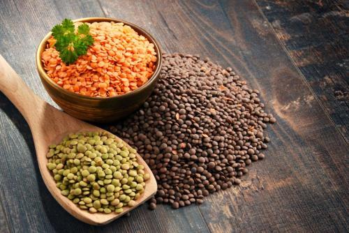 a group of pulses and a bowl of lentils and a wooden spoon at Gîte familiale au cœur du village in Villiers-au-Bouin