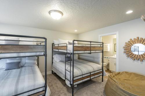 a bedroom with two bunk beds and a bathroom at Live All In in St. George