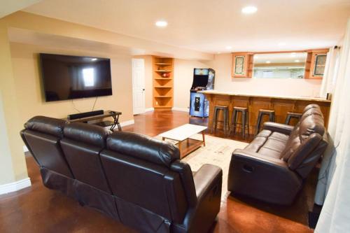 a living room with a couch and a bar at 6 King Bedrooms, Sleeps 20, 8 Rooms, Bikes, HotTub in Lindon