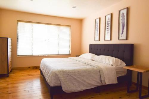 a bedroom with a large bed and a window at 6 King Bedrooms, Sleeps 20, 8 Rooms, Bikes, HotTub in Lindon