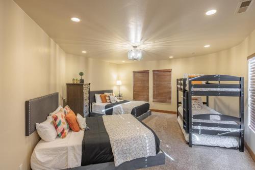 a bedroom with two beds and two bunk beds at Chip Shot in St. George