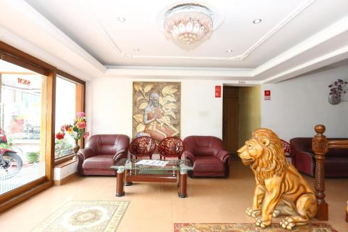 a living room with a lion sitting on the floor at OYO Suba Krishmaa Residency in Kodaikānāl